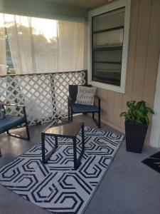 a rug on a porch with a table and a chair at Life is good in St. Petersburg