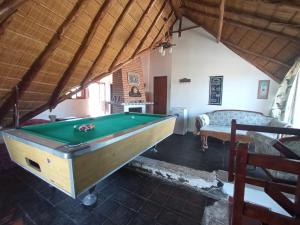 a room with a pool table and a bed at Pucara del Este in Punta del Este