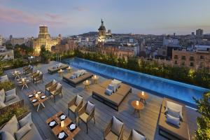 a rooftop bar with a view of a city at Mandarin Oriental, Barcelona in Barcelona