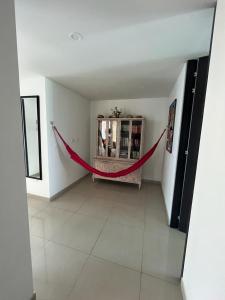 a hallway with a red rope in a room at Apartamento Amoblado Villeta in Villeta