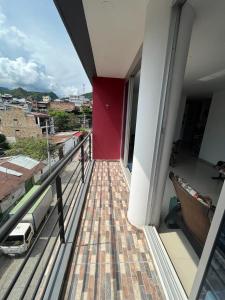 a balcony of a building with a red wall at Apartamento Amoblado Villeta in Villeta