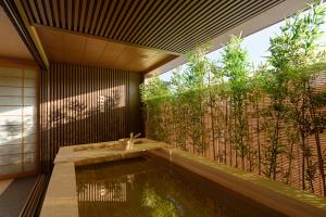 a house with a pool in the middle of a garden at Hoshikage Ryokan Hotel in Busan