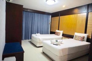 Postel nebo postele na pokoji v ubytování Suppamitr Villa Hotel