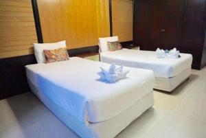Postel nebo postele na pokoji v ubytování Suppamitr Villa Hotel