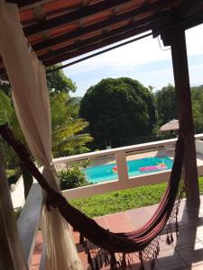 a hammock with a view of a swimming pool at Linda Chácara com Piscina in Arujá