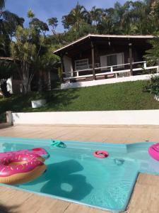 a swimming pool with an inflatable swim ring in a house at Linda Chácara com Piscina in Arujá