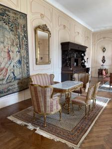 a dining room with a table and chairs at Chateau La Rametiere in Plomb