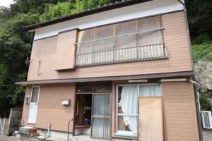 a house with a large window and a balcony at Sakitsu house SEI - Vacation STAY 51020v in Amakusa