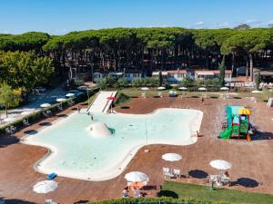 a large pool with a slide and a playground at Mobile Home in Cesenatico by Adriatic Sea in Cesenatico