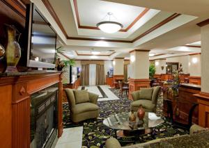 a lobby of a hotel with a fireplace at Holiday Inn Express Hotel and Suites Ada, an IHG Hotel in Ada