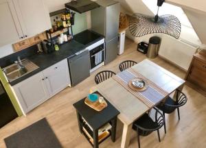 a kitchen and dining room with a table and chairs at Le petit St-Jean in Bagnères-de-Bigorre