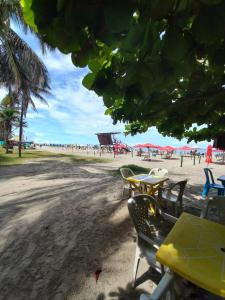 a group of tables and chairs on the beach at Apt Edificio los Delfines Playa in Cartagena de Indias