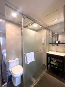 a bathroom with a toilet and a shower and a sink at Hotel Puri in Taipei