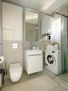 a bathroom with a washing machine and a washer at Light Room by Zoom Apartments in Bratislava