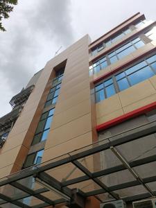 a tall building with many windows on it at Odua Golden Mansyur Medan in Medan