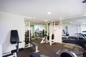 a gym with several tread machines and a mirror at Exclusive Stays - The Summit in Melbourne