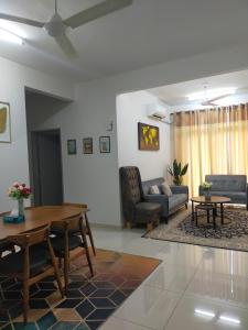 ein Wohnzimmer mit einem Tisch und einem Sofa in der Unterkunft D DAIM HOMESTAY @ PRIMA MERU in Ipoh
