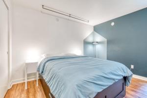 a bedroom with a large bed with blue sheets at Portland Blues in Portland