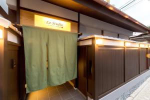 a row of stalls in a building with a green curtain at Le Studio 五条高倉 in Kyoto