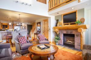 a living room with a fireplace and a tv at 3 Bedroom Condo - The Lodges at Deer Valley condo in Park City