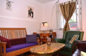 a living room with a couch and chairs and a table at City Oasis Apartment in Belgrade