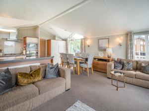 a living room with a couch and a dining room at Links Lodge in Grange Over Sands