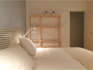 a bedroom with a white bed and a shelf at GREAT LOCATION & 130m2! Guggenheim & Parking in Bilbao