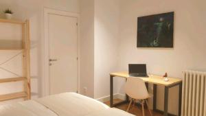 1 dormitorio con escritorio y ordenador portátil. en GREAT LOCATION & 130m2! Guggenheim & Parking, en Bilbao