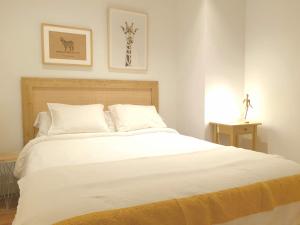 a bedroom with a large bed with white sheets at GREAT LOCATION & 130m2! Guggenheim & Parking in Bilbao