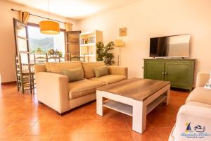 a living room with a couch and a table at El Velero Sotillo La Jarana Piscina Parking in San José
