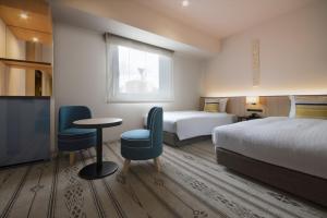 Postel nebo postele na pokoji v ubytování Hotel Vista Fukuoka Nakasu-Kawabata