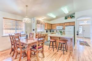 a kitchen and dining room with a table and chairs at Peaceful Fresno Home, Near Popular Wineries! in Fresno