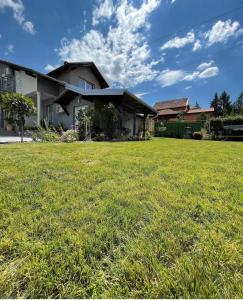 a house with a green lawn in front of it at Residence Provence New in Vrdnik