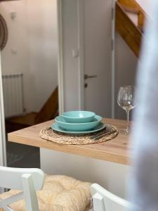 a table with a stack of plates and a glass at Residence Provence New in Vrdnik +32 photos