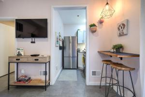 a kitchen with a counter and a kitchen with a refrigerator at Cozy Philadelphia Studio, Near Center City! in Philadelphia