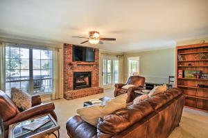 a living room with leather furniture and a fireplace at Ideal Chickamauga Lake Home and Dock and Fire Pit in Soddy-Daisy