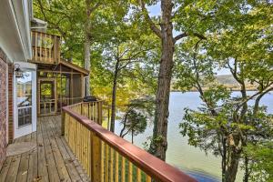 a house with a deck with a view of the water at Ideal Chickamauga Lake Home and Dock and Fire Pit in Soddy-Daisy