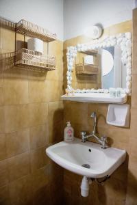 a bathroom with a sink and a mirror at Arriba Apartments in Afissos