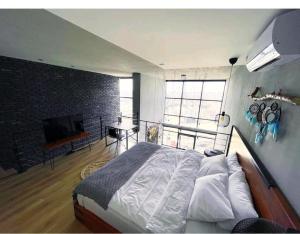 a bedroom with a large bed and a television at FSM home in Nilüfer