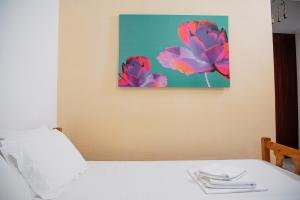 a bedroom with a bed with a painting on the wall at Arriba Apartments in Afissos