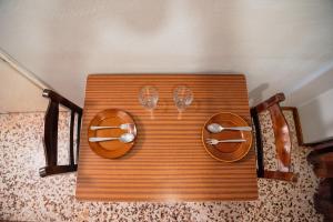 a wooden table with glasses on top of it at Arriba Apartments in Afissos