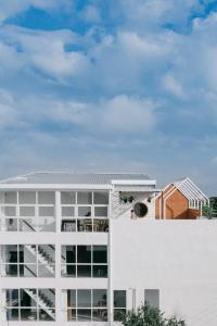 an image of a white building at Grow home -Stay and space, Self check-in in Chiang Rai