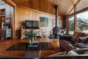 a living room with a couch and a tv at Kangaroo Manor in Yarra Junction