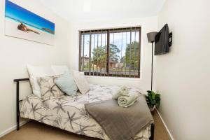 a room with a bed and a window at Wildwood I Pet Friendly I 5 Mins to Beach in Callala Beach