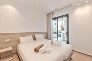 a bedroom with a white bed with towels on it at Jardines - Tabor 2 1 POOL VIEW 2B in Palm-Mar +16 photos