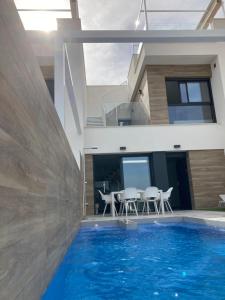 a house with a swimming pool in front of a house at Casa Flamencos in Rojales