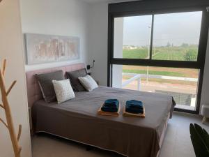a bedroom with a bed with two towels on it at Casa Flamencos in Rojales +32 photos