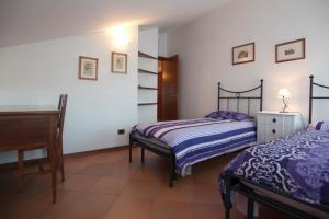 En eller flere senge i et værelse på Attico del Picchio