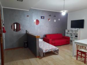 sala de estar con sofá rojo y silla roja en BIKE HOUSE 2 "evo", en Seriate
