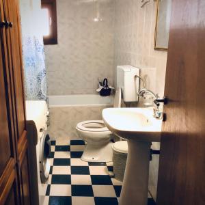 a bathroom with a toilet and a sink at Agrampeli in Limenaria